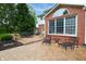An inviting brick patio features an outdoor dining area and additional seating, perfect for relaxation and entertaining at 10390 Tremont Dr, Fishers, IN 46037