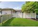 Backyard with privacy fence, lush green grass, and mature trees at 1045 Millwood Ct, Indianapolis, IN 46260