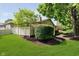 Exterior view of backyard with well-manicured lawn, mature trees, and privacy fence at 1045 Millwood Ct, Indianapolis, IN 46260