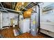 Utility area with washer, dryer, hot water heater, and laminate wood flooring at 1045 Millwood Ct, Indianapolis, IN 46260