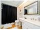 Well-lit bathroom featuring white vanity, decorative mirror, and a shower-tub combination at 1045 Millwood Ct, Indianapolis, IN 46260