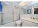 Bathroom featuring tiled shower with glass doors, white toilet, and vanity at 1045 Millwood Ct, Indianapolis, IN 46260