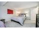 Carpeted bedroom with double bed, colorful wall art, and bedside tables at 1045 Millwood Ct, Indianapolis, IN 46260