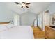 Light-filled bedroom with hardwood floors, neutral walls, and large windows provides a relaxing space at 1045 Millwood Ct, Indianapolis, IN 46260