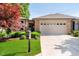 Charming single-story home with brick accents, manicured lawn, and an attached two-car garage at 1045 Millwood Ct, Indianapolis, IN 46260