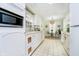 Bright eat-in kitchen featuring white cabinets, stainless steel microwave, and tile floors at 1045 Millwood Ct, Indianapolis, IN 46260