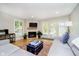 Cozy living room with a fireplace, hardwood floors, and comfortable seating at 1045 Millwood Ct, Indianapolis, IN 46260