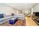 Inviting living room with hardwood floors, a large sectional sofa, and stylish decor at 1045 Millwood Ct, Indianapolis, IN 46260