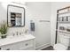 Well-lit bathroom featuring a modern vanity, stylish fixtures, and decorative shelving unit at 1048 St Peter St, Indianapolis, IN 46203