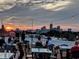 Outdoor rooftop seating area with skyline view during sunset for an enjoyable city dining experience at 1048 St Peter St, Indianapolis, IN 46203
