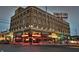 Exterior of brick building in Fountain Square in Indianapolis at night with street traffic and neon signs at 1048 St Peter St, Indianapolis, IN 46203