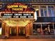 Exterior view of the illuminated Fountain Square Theatre entrance, advertising Friday swing dance lessons at 1048 St Peter St, Indianapolis, IN 46203