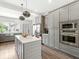 Open kitchen featuring a large island, stainless appliances, and gray cabinetry at 1048 St Peter St, Indianapolis, IN 46203