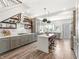 Modern gray kitchen with stainless appliances, island, and stylish lighting at 1048 St Peter St, Indianapolis, IN 46203