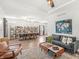 Open-concept living area showcasing hardwood floors, a modern sofa, and an adjacent dining space at 1048 St Peter St, Indianapolis, IN 46203