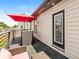 Inviting patio with outdoor seating, an umbrella for shade, and a stylish exterior door at 1048 St Peter St, Indianapolis, IN 46203