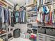 Organized walk-in closet with shelving, hanging rods, and storage baskets for optimal storage and organization at 1048 St Peter St, Indianapolis, IN 46203