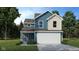 Charming two-story home featuring blue siding, a two-car garage, and a well-manicured lawn at 1105 Lona Dr, Martinsville, IN 46151