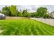 Spacious backyard showcasing a meticulously mowed lawn and wooden privacy fence at 11674 Timken Ct, Fishers, IN 46037