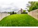 Expansive backyard with lush green lawn, bordered by wood fences for added privacy at 11674 Timken Ct, Fishers, IN 46037