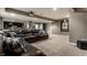Spacious finished basement with large leather sectional sofa and neutral carpet at 11674 Timken Ct, Fishers, IN 46037