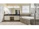 Bright bathroom with a large mirror, dual sinks, soaking tub, and a walk-in shower at 11674 Timken Ct, Fishers, IN 46037