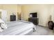 Bright bedroom featuring neutral walls, a TV, dresser, and a plush bed with grey and white bedding at 11674 Timken Ct, Fishers, IN 46037