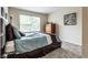Cozy bedroom featuring a comfortable bed, dresser, window and carpet at 11674 Timken Ct, Fishers, IN 46037