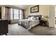 Sun-filled bedroom with vaulted ceiling, decorative headboard, and carpet floors at 11674 Timken Ct, Fishers, IN 46037