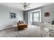 Serene bedroom featuring a chair, bay window, and a small desk and shelves with decor at 11674 Timken Ct, Fishers, IN 46037