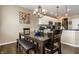 Dining area showcasing a wood table, white cabinets, granite countertops, and stainless appliances at 11674 Timken Ct, Fishers, IN 46037