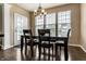 Traditional dining room with a wooden table, chairs, chandelier, and natural light from the backyard at 11674 Timken Ct, Fishers, IN 46037