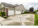 Long driveway leading to a two-car garage, complemented by fresh landscaping at 11674 Timken Ct, Fishers, IN 46037