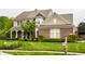 Beautiful two-story home with brick and siding, a covered porch, manicured lawn, and a mailbox at 11674 Timken Ct, Fishers, IN 46037