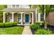 Inviting front porch with chairs, lush landscaping, and a bright blue front door for curb appeal at 11674 Timken Ct, Fishers, IN 46037