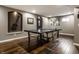 Basement game room featuring a ping pong table and hardwood floors at 11674 Timken Ct, Fishers, IN 46037