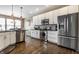 Bright kitchen with stainless appliances, granite countertops, tile backsplash and hardwood floors at 11674 Timken Ct, Fishers, IN 46037