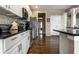 Kitchen with granite countertop, stainless steel appliances, hardwood floors, and white cabinets at 11674 Timken Ct, Fishers, IN 46037