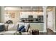 Open concept living room view to kitchen with stainless appliances, granite counters and pendant lighting at 11674 Timken Ct, Fishers, IN 46037