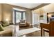 Bright living room featuring hardwood floors, neutral walls, bay windows and comfortable furniture at 11674 Timken Ct, Fishers, IN 46037