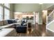 Spacious living room with fireplace, hardwood floors, and an open floor plan with kitchen and dining area at 11674 Timken Ct, Fishers, IN 46037