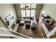 Overhead view of living room featuring fireplace, hardwood floors, staircase, and an open-concept layout at 11674 Timken Ct, Fishers, IN 46037