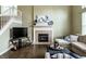 Comfortable living room with fireplace, hardwood floors, staircase, and plush sectional sofa at 11674 Timken Ct, Fishers, IN 46037