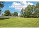Backyard featuring large, green lawn with wooden fence at 11733 East 21St St, Indianapolis, IN 46229