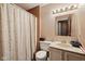 Functional bathroom with a shower curtain, classic vanity, and neutral color scheme at 11733 East 21St St, Indianapolis, IN 46229