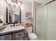 Charming bathroom with wood vanity, framed mirror, and glass shower at 11733 East 21St St, Indianapolis, IN 46229