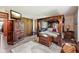 Spacious bedroom featuring a four-poster bed, ample storage, and a cozy seating area at 11733 East 21St St, Indianapolis, IN 46229