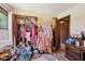 Walk-in closet filled with clothes, shoes, and accessories, needing organization for optimal use at 11733 East 21St St, Indianapolis, IN 46229