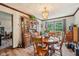 Elegant dining room with wood floors, hutch, and natural light from the window at 11733 East 21St St, Indianapolis, IN 46229