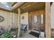 Inviting front porch with stone accents, a wooden bench, and a decorative front door at 11733 East 21St St, Indianapolis, IN 46229
